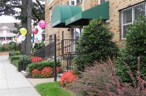 Washington apartment for rent - a building with green awnings and balloons on the sidewalk